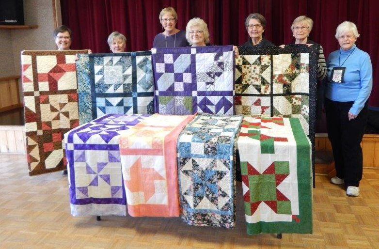 Quilts by Quilters at Blind Bay Canada with their finished "Cinnamon-teen Chocolate Figs & Roses" 2006 BOM quilts.