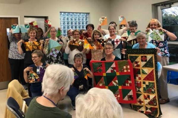 The Kindred Spirits Quilt Guild are making the “Mistletoe in the Corner” BOM quilt designed by TK Harrison. This is a photo of their Blocks #8 & #9! There are also a couple of finished quilts in the photo!