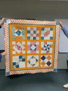 "Happiness is Quilting" a 2017 BOM quilt made by Deanna H. from the El Campo Casual Quilt Guild. It's an original quilt design by TK Harrison from BOMquilts.com!