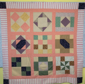 "Happiness is Quilting" 2017 BOM quilt is an original design by TK Harrison. Made by a member of the Piecemakers Quilt Guild!