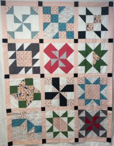 Angie B. sewed my original design "Cinnamon-teen Chocolate Figs & Roses" BOM quilt together!