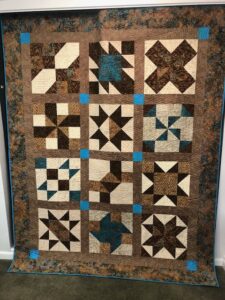 Annette K. sewed my original design "Cinnamon-teen Chocolate Figs & Roses" BOM quilt together!