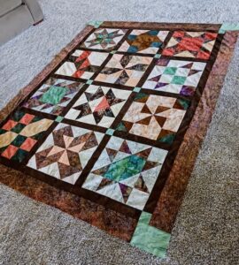 Joyce C. sewed my original design "Cinnamon-teen Chocolate Figs & Roses" BOM quilt together!