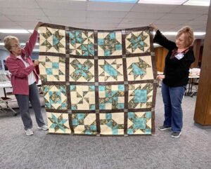 "Cinnamon-teen Chocolate Figs & Roses" BOM quilt sewn together by Jyl of the Central Kansas ThreadBenders Quilt Guild! This quilt was designed exclusively for BOMquilts.com!